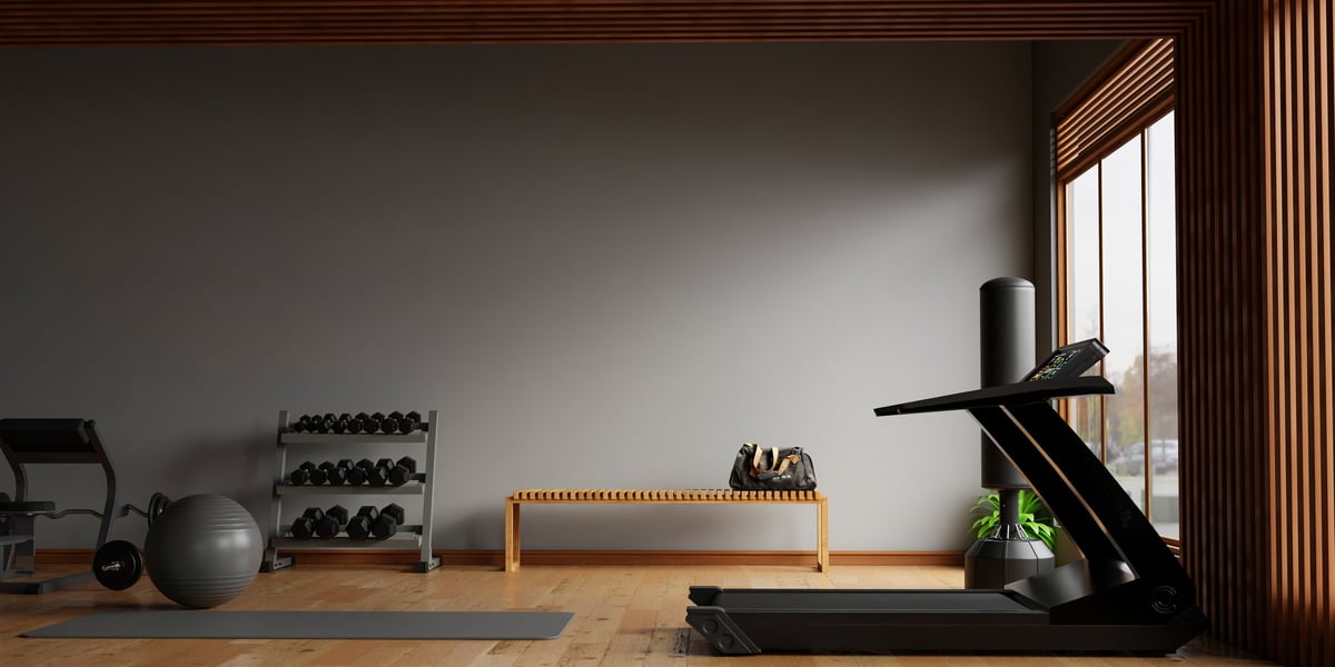 Dark modern gym interior with fitness equipment and dramatic lighting