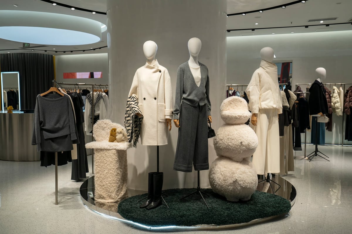 Clothing store display with neatly arranged apparel on racks